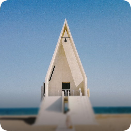 The picture shows a simple, modern white house on a beach by the sea—very romantic.